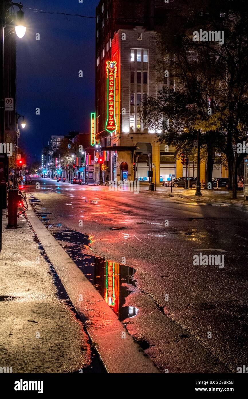 Rue Sainte-Catherine at the intersection of rue Berri at night in the rain Stock Photo