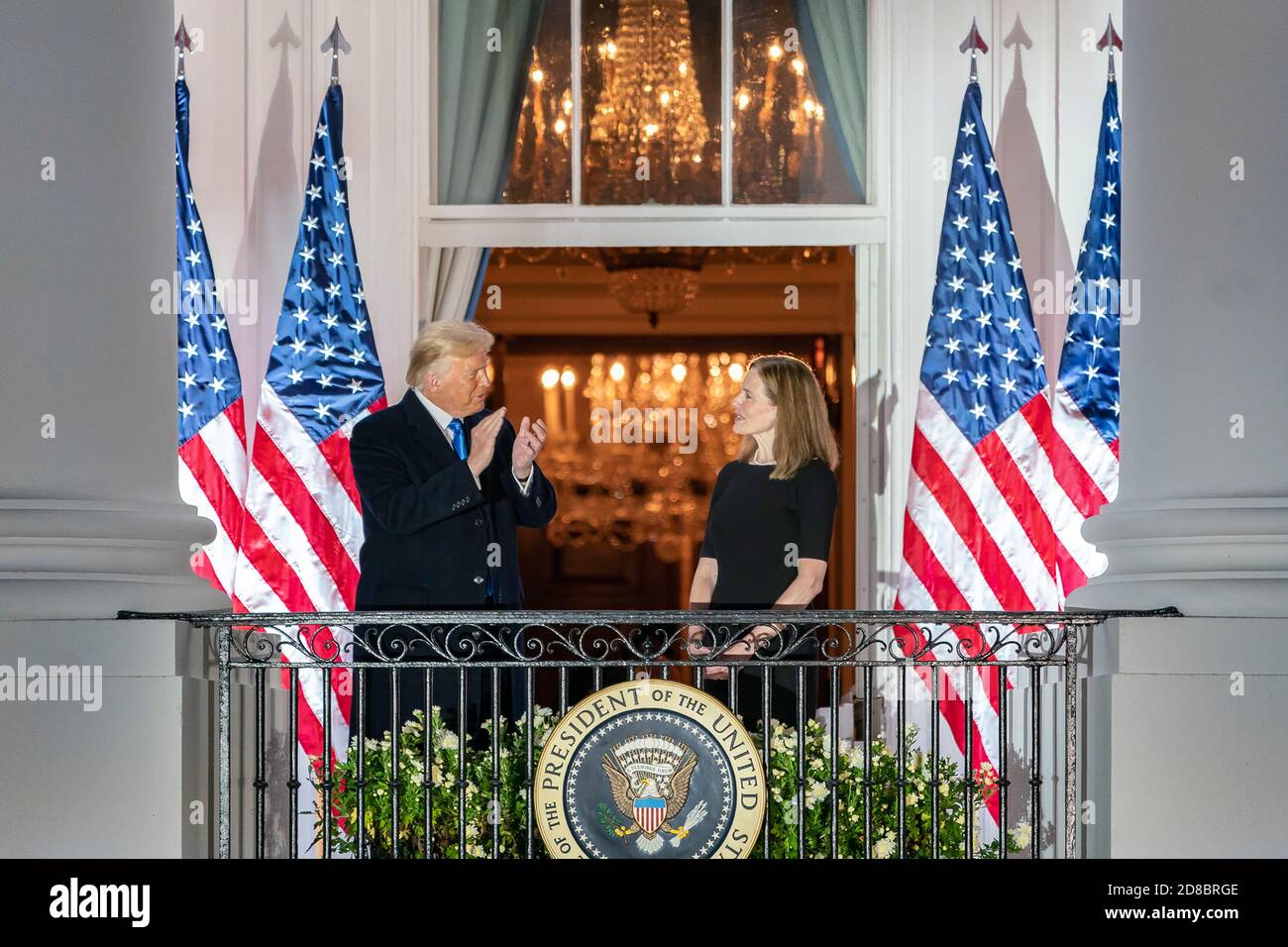 President Donald J. Trump applauds U.S. Supreme Court Associate Justice Amy Coney Barrett from the Blue Room Balcony of the White House Monday, October 26, 2020, after attending Justice Barrett’s swearing-in ceremony on the South Lawn. (USA) Stock Photo