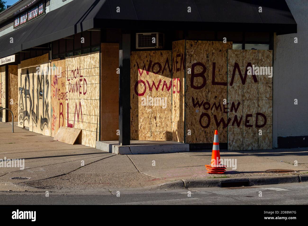 Minneapolis, MN - May 30, 2020: Sea Wolf Tattoo Co. boarded up at the  aftermath scene of the George Floyd Black Lives Matter protest and riots on  May 30, 2020 in Minneapolis,