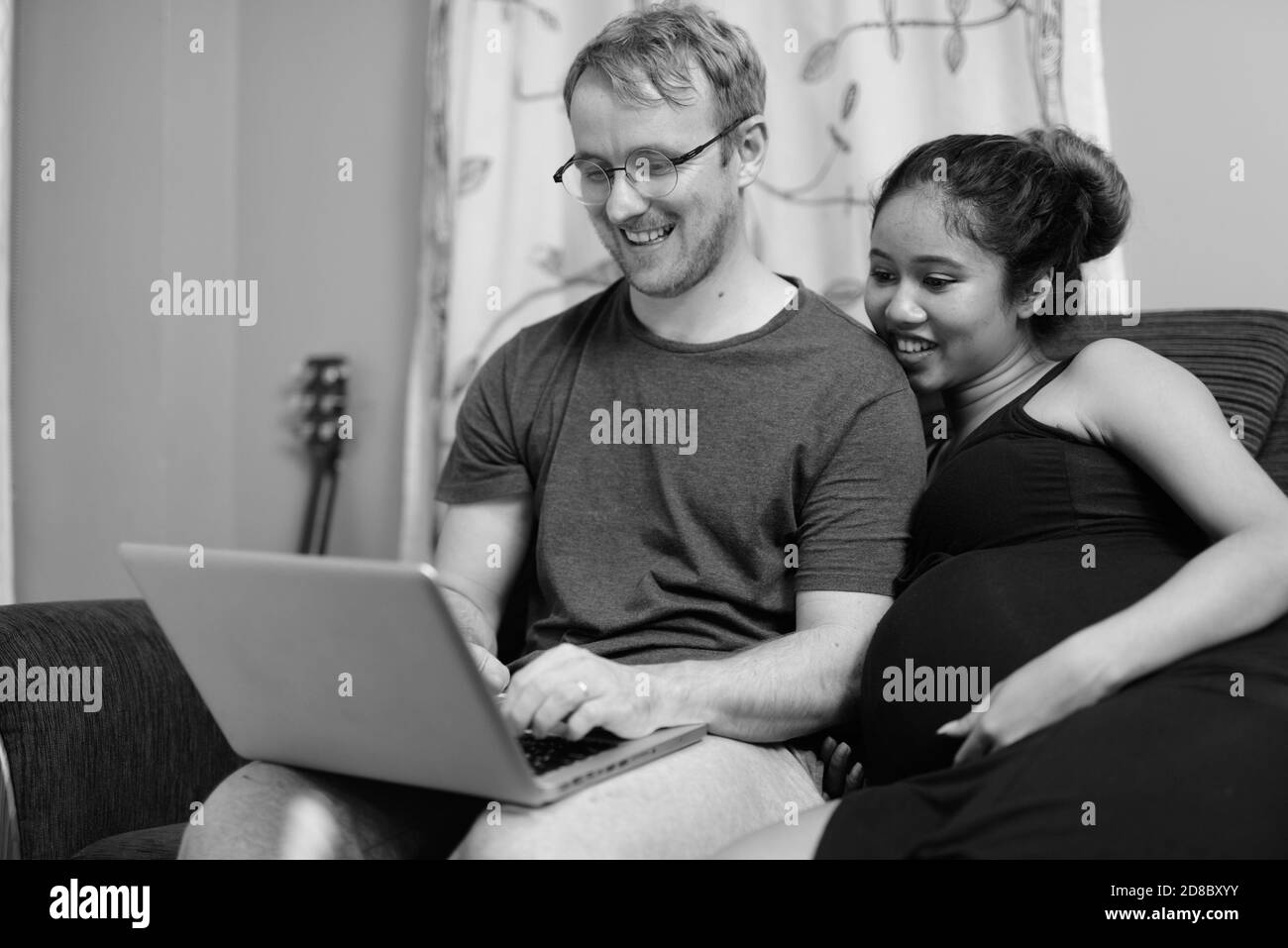Multi ethnic couple married and in love in the living room Stock Photo
