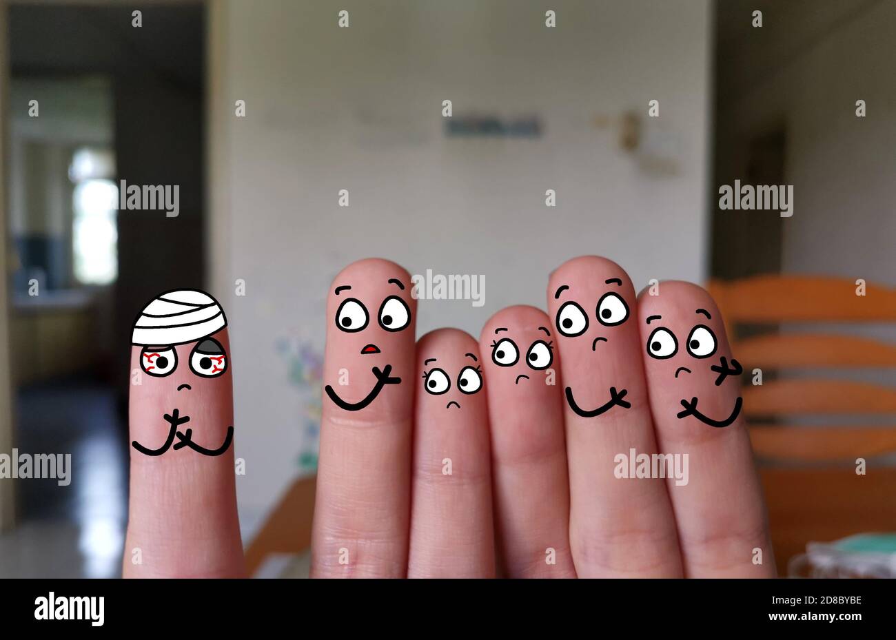 Six fingers are decorated as six person. One of them is suffering from traumatic brain injury. Stock Photo