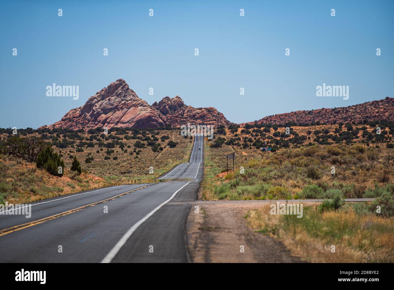 Desert highway at sunset, travel concept, USA. Asphalt road and canyon background. Stock Photo