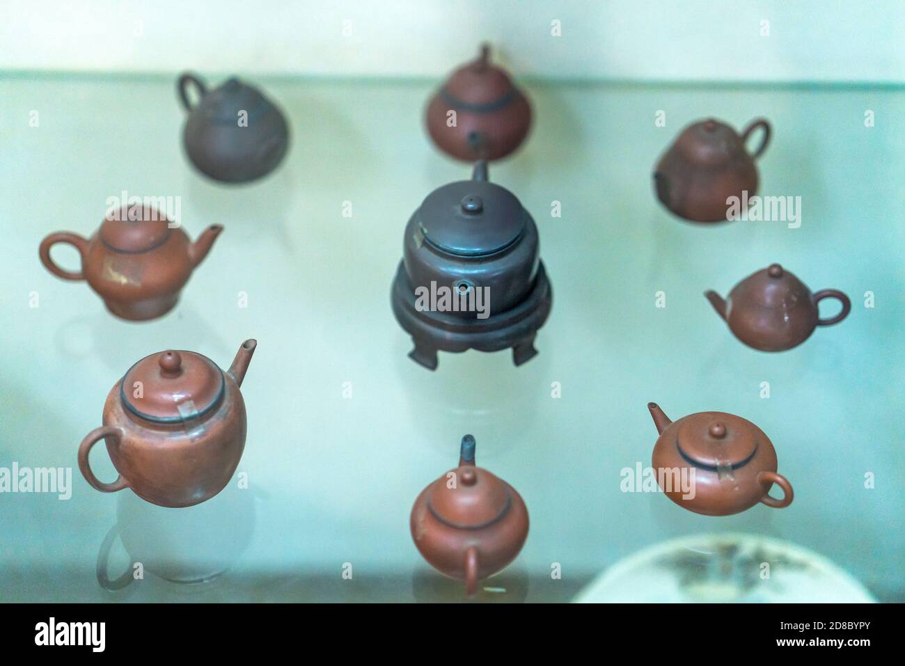 Set of teapots and the old tea cup on the table exhibited as old furniture collection. This is the vestiges of feudal tea art Stock Photo