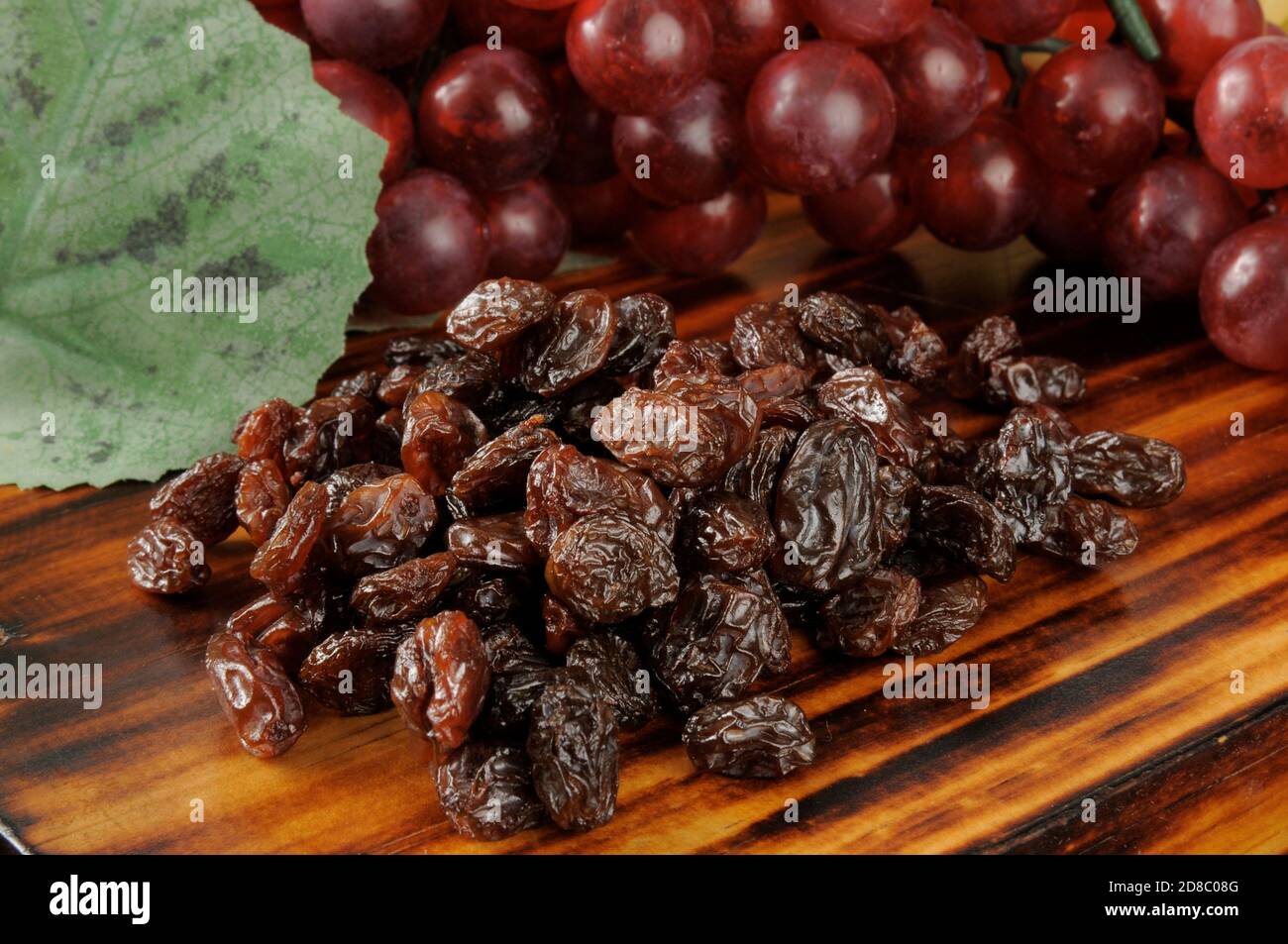 Sun dried raisins with a bunch of grapes Stock Photo Alamy