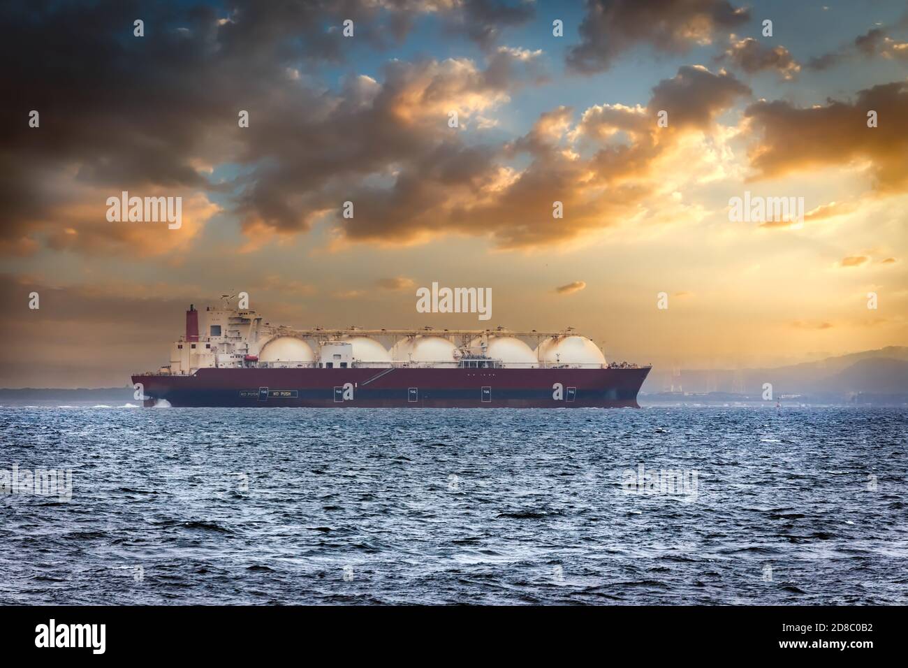A Liquid Natural Gas tanker (LNG) in Japan’s Tokyo Bay at sunrise. Stock Photo