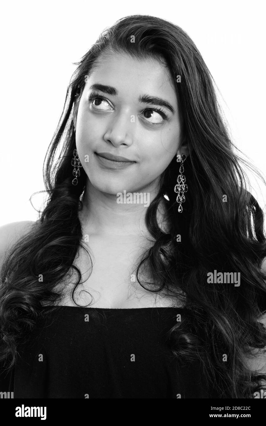Young beautiful Indian woman thinking while looking up Stock Photo - Alamy