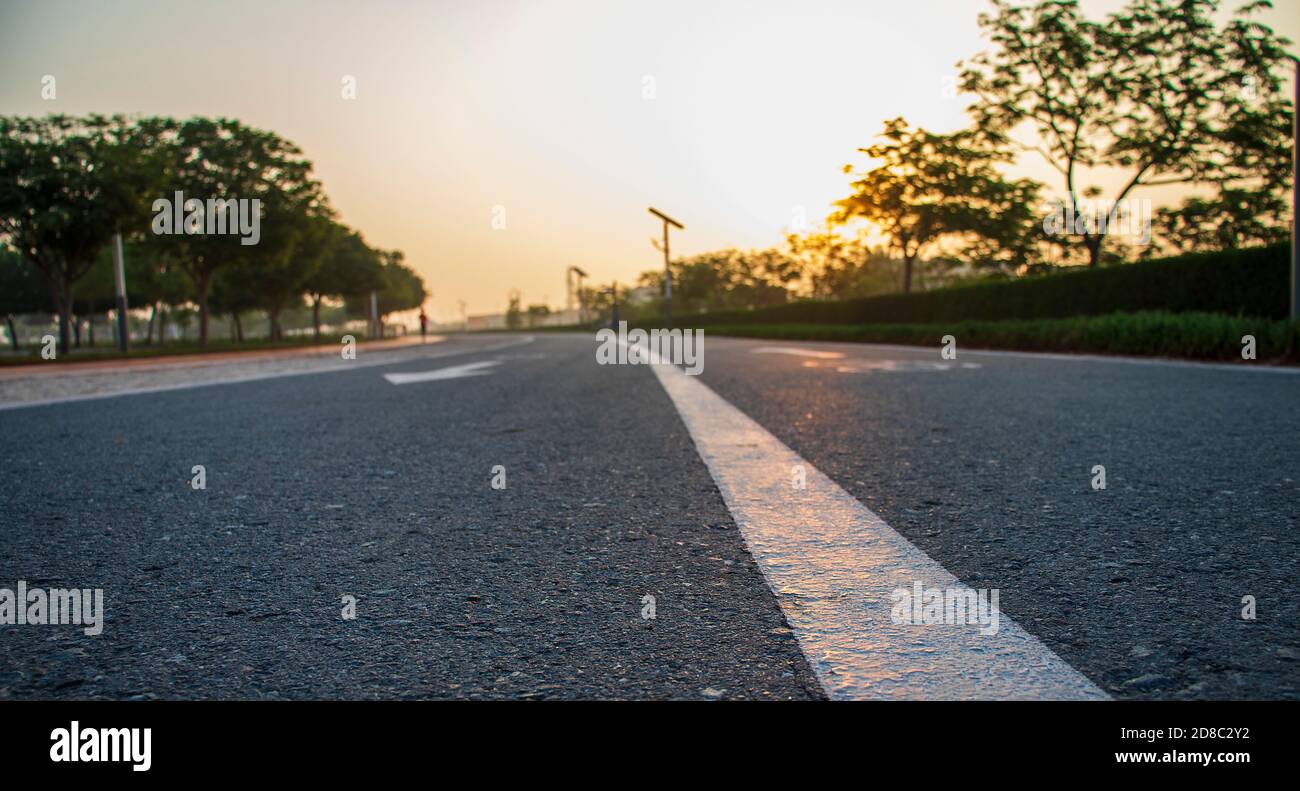 Jogging and cycling tracks in Al Warqa park Dubai UAE early in the morning. Lamp post powered by solar panels can be seen in the picture as well as Stock Photo