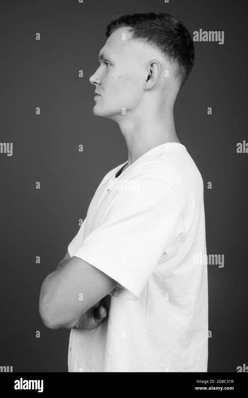 Young man side view crossed arms Black and White Stock Photos & Images ...