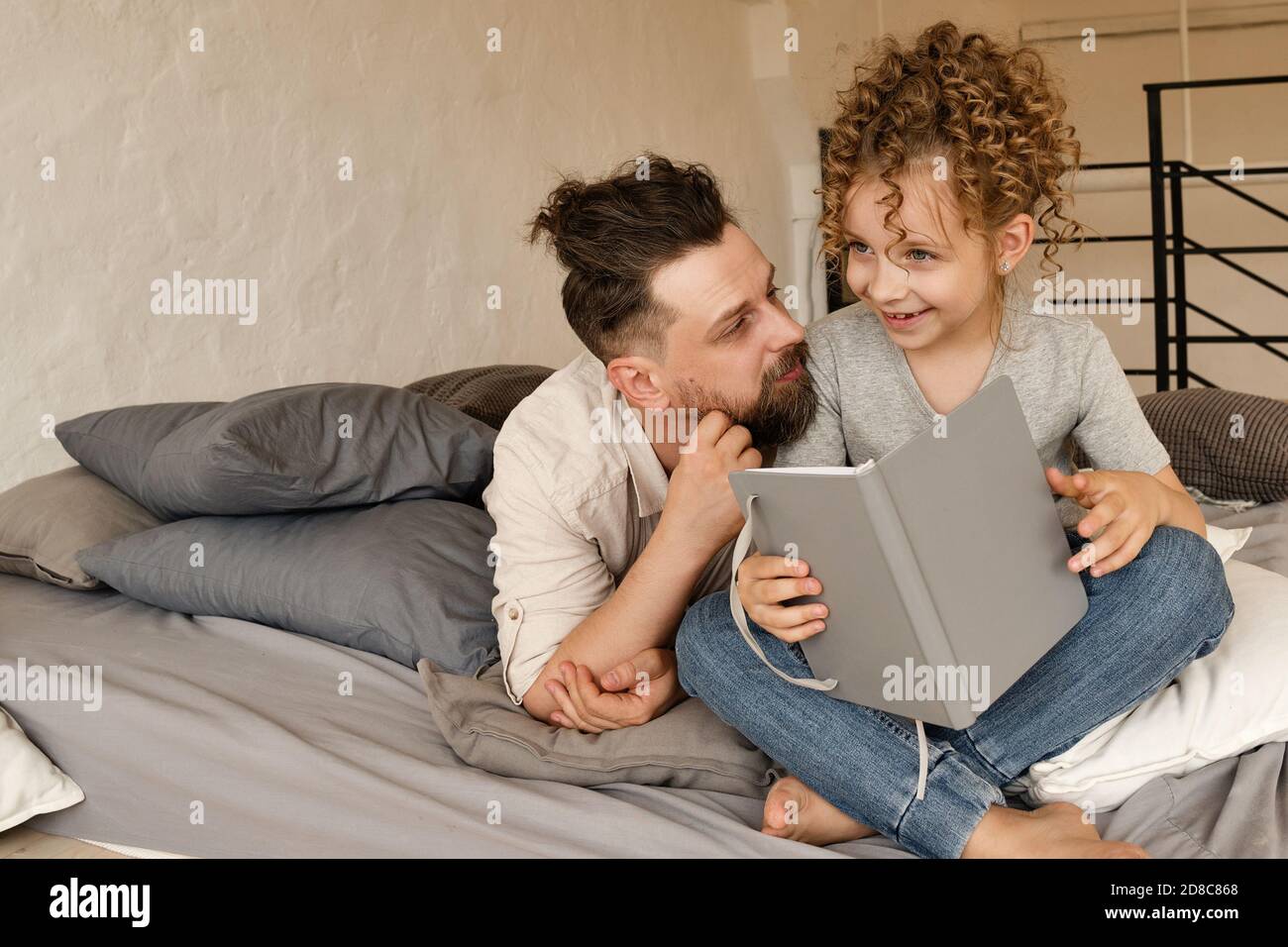 Little girl can read by herself. Daughter reads funny stories for dad.  Happy family. Spend time together Stock Photo - Alamy