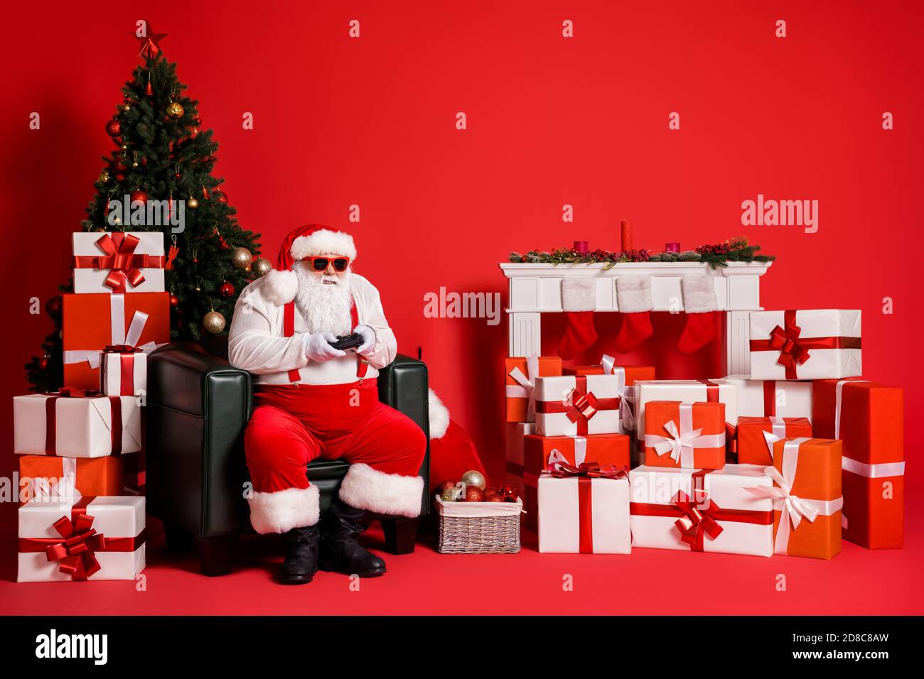 Portrait of his he attractive funky fat overweight addicted focused Santa father sitting in armchair playing psp contest competition isolated bright Stock Photo