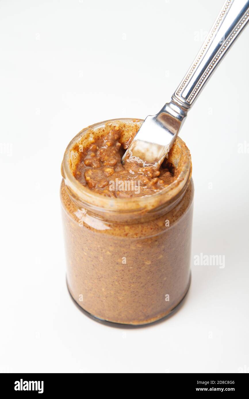 An open jar of crunchy peanut butter Stock Photo Alamy
