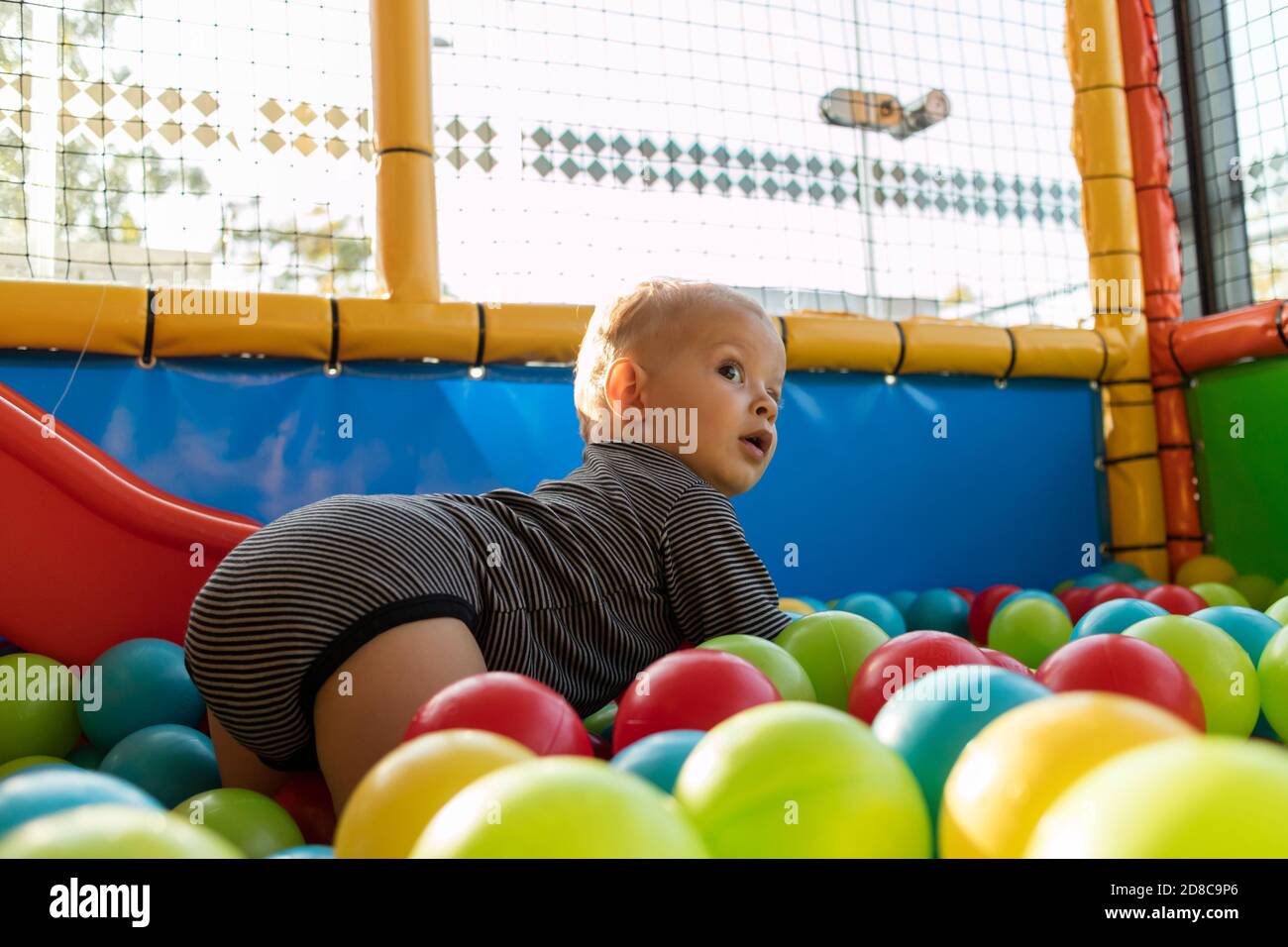 Baby Playing In Playground with Colorful Ball Stock Photo Alamy