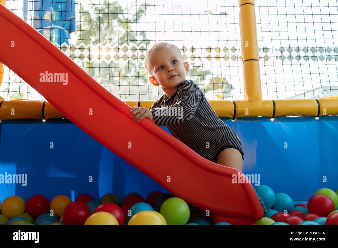 Baby Playing In Playground with Colorful Ball Stock Photo Alamy