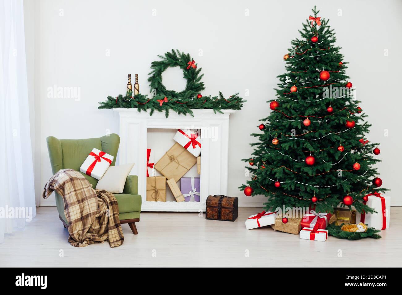 Christmas Tree With Gifts By The Fireplace For The New Year Decor Of The House 2021 2022 Stock Photo - Alamy