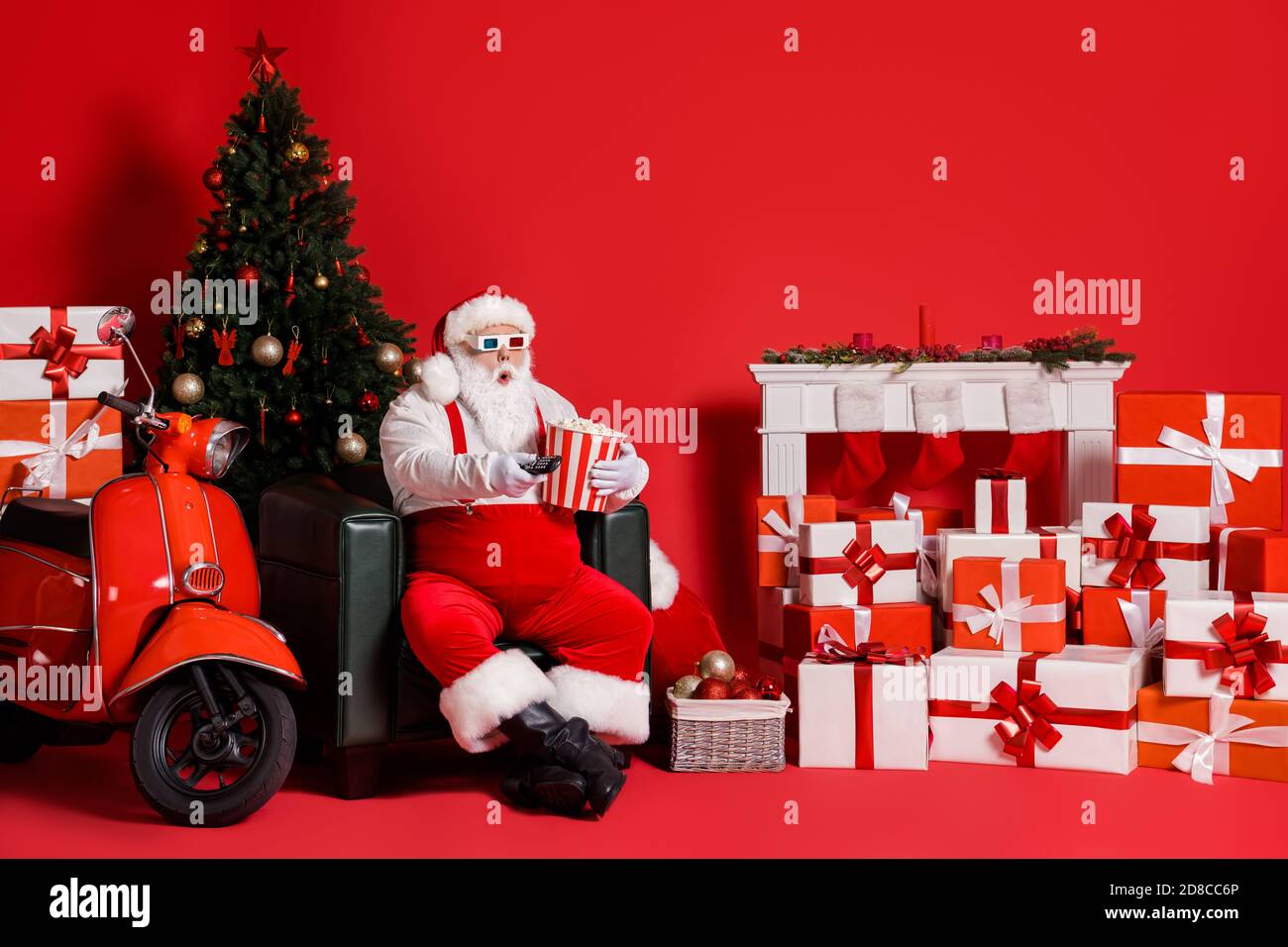 https://c8.alamy.com/comp/2D8CC6P/full-length-photo-of-astonished-santa-claus-switch-control-3d-film-hold-pop-corn-box-isolated-on-red-color-background-with-x-mas-ornament-2D8CC6P.jpg