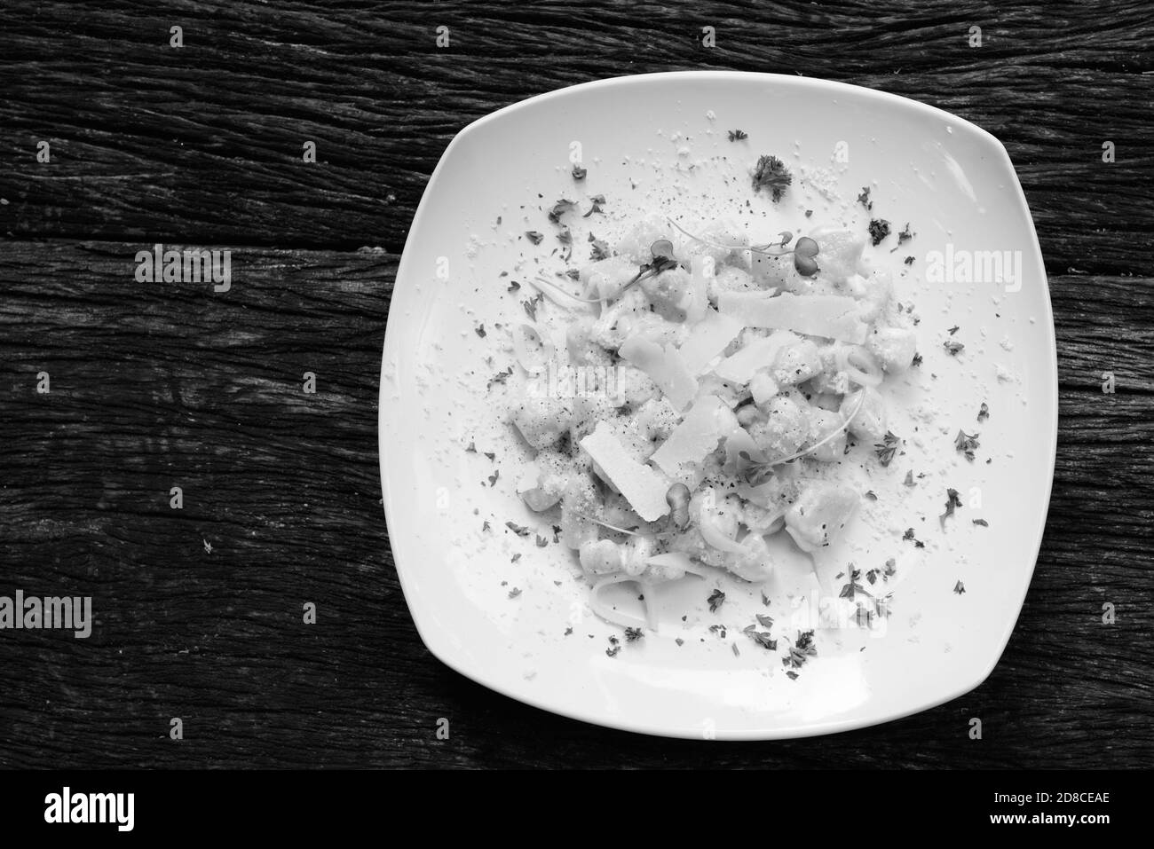 Gnocchi Mixed with Cheese And Cream Against Wooden Table Stock Photo