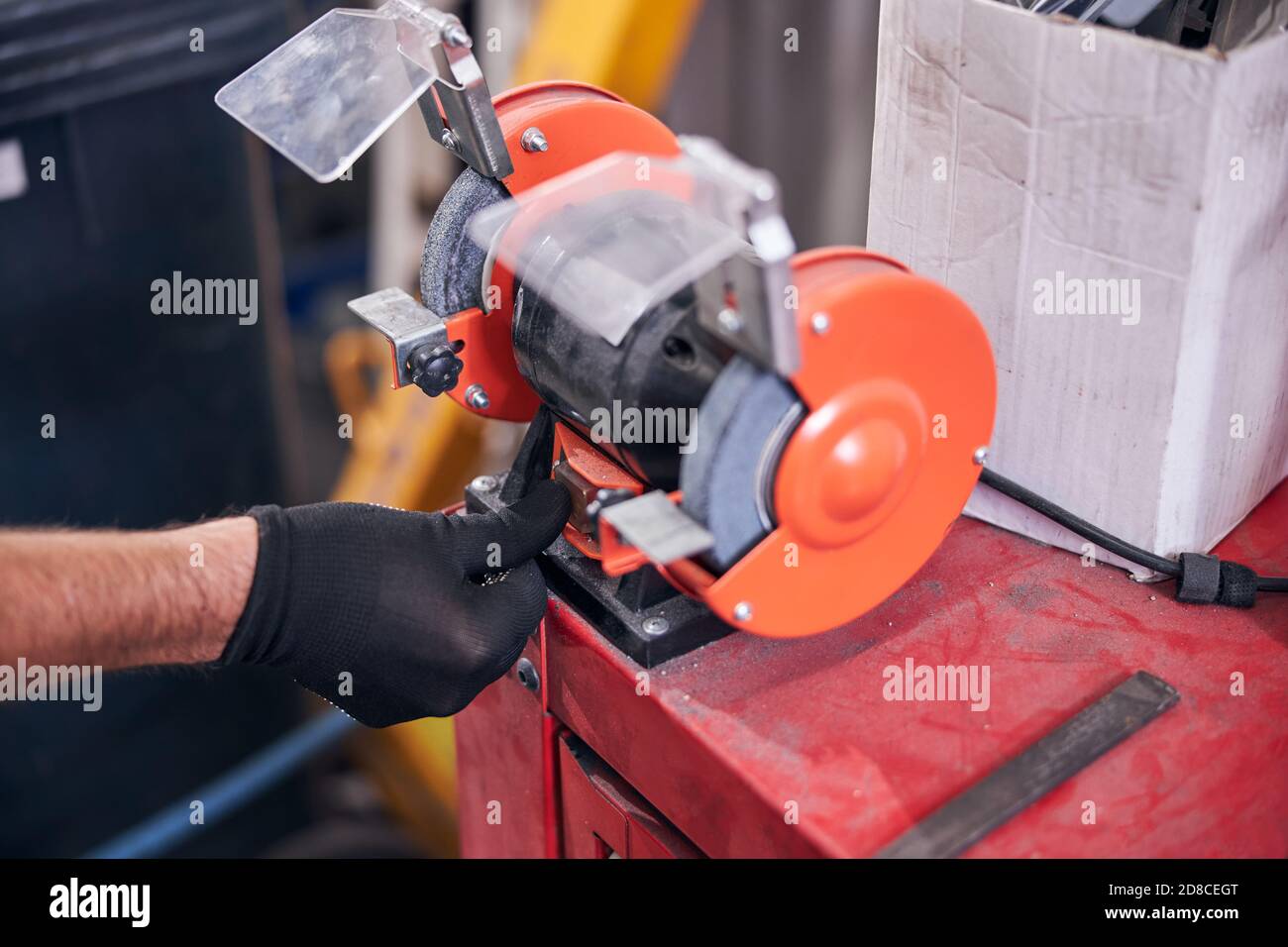 Mechanic using grinding machine at auto repair shop Stock Photo Alamy