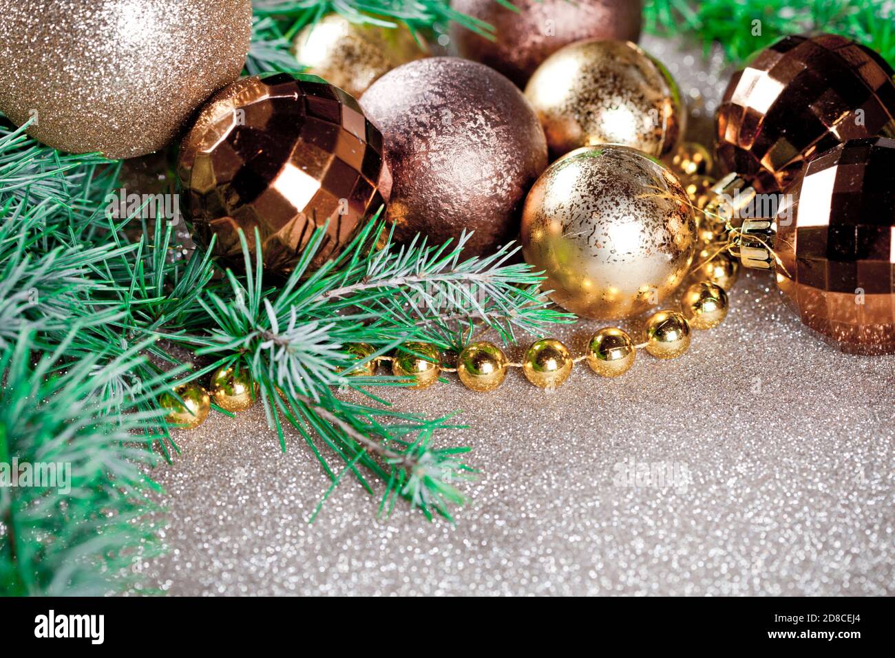 Christmas decorations and evergreen fir tree branch closeup on gold ...