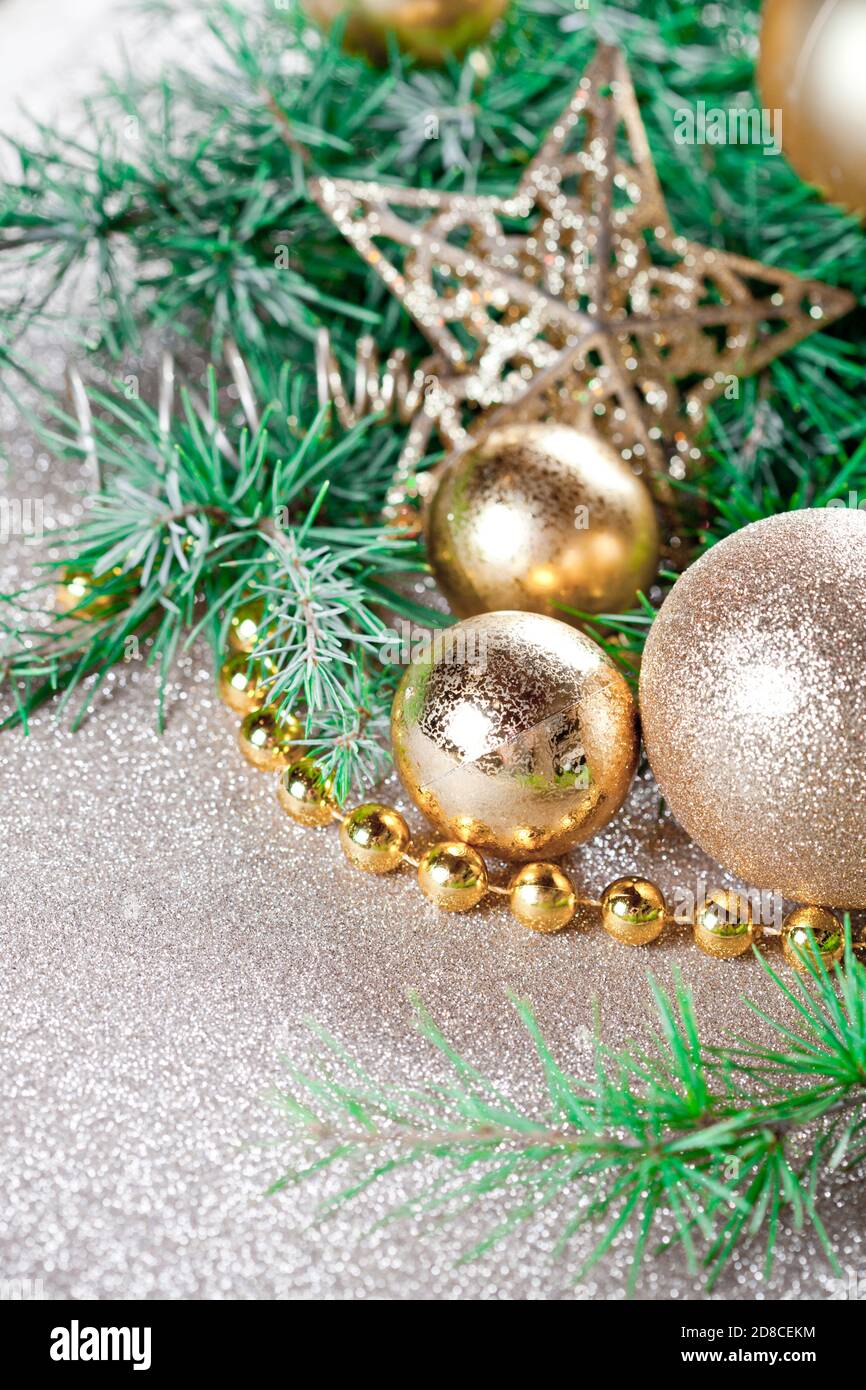 Christmas decorations and evergreen fir tree branch closeup on gold ...