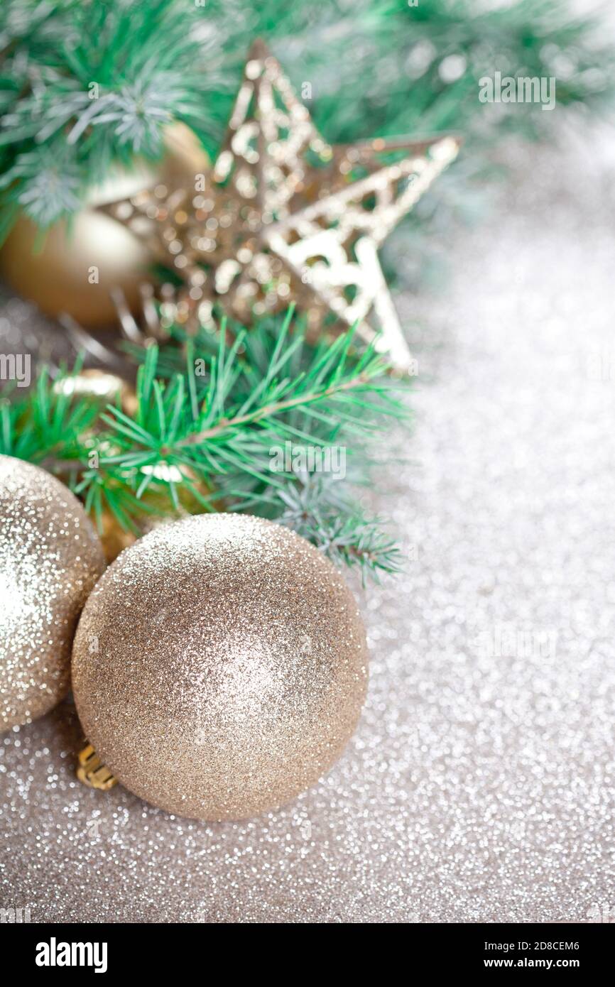 Christmas decorations and evergreen fir tree branch closeup on gold ...