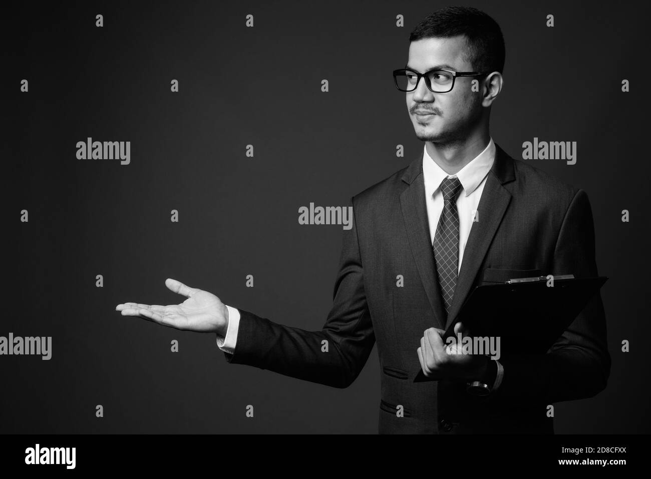 Asian man in suit showing Black and White Stock Photos & Images - Alamy