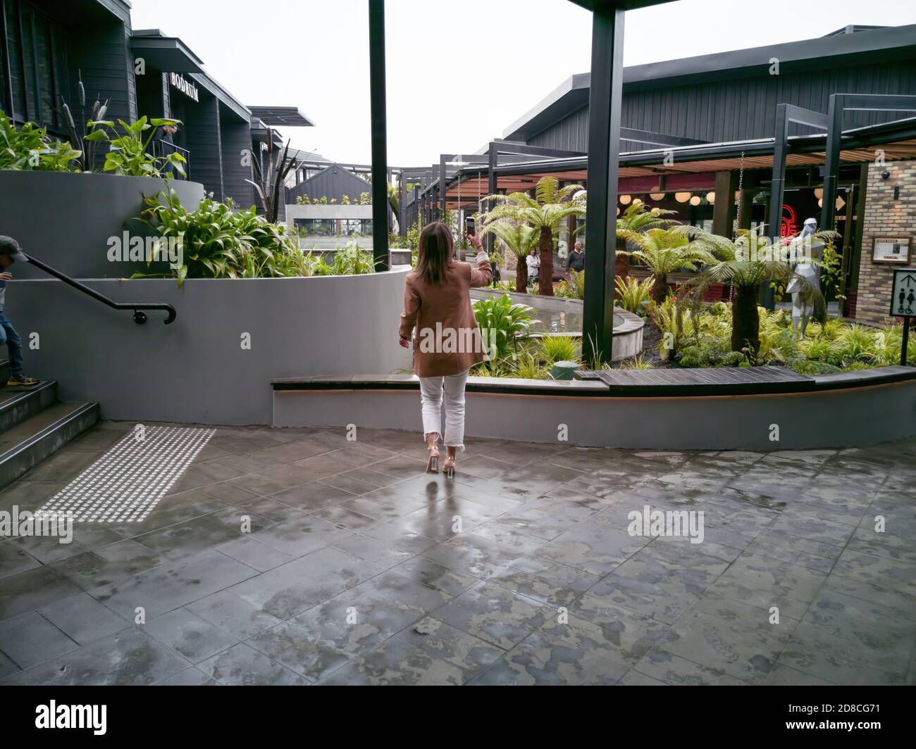 AUCKLAND, NEW ZEALAND - Oct 10, 2019: View of woman taking picture of rooftop dining and entertainment precinct terrace in Westfield Newmarket Shoppin Stock Photo