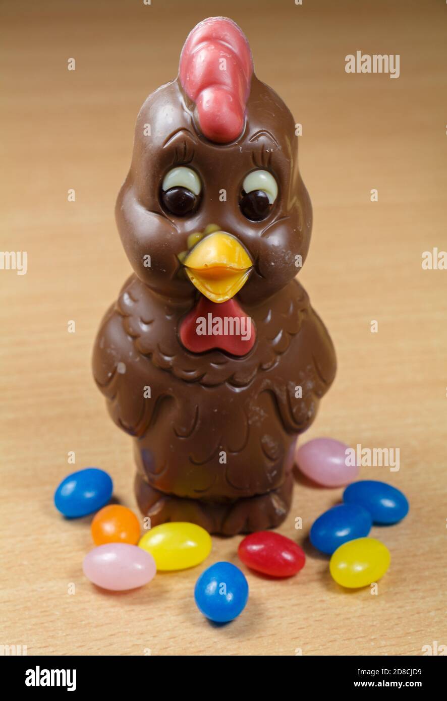 Milk chocolate hen and multicolored sugar candies for Easter Stock