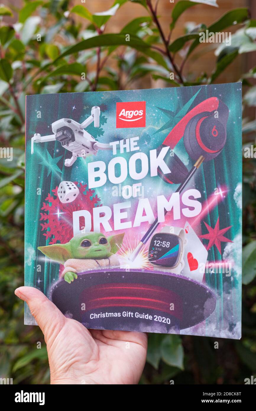 Hand holding a 2020 Argos Catalogue (Book of Dreams Christmas Gift