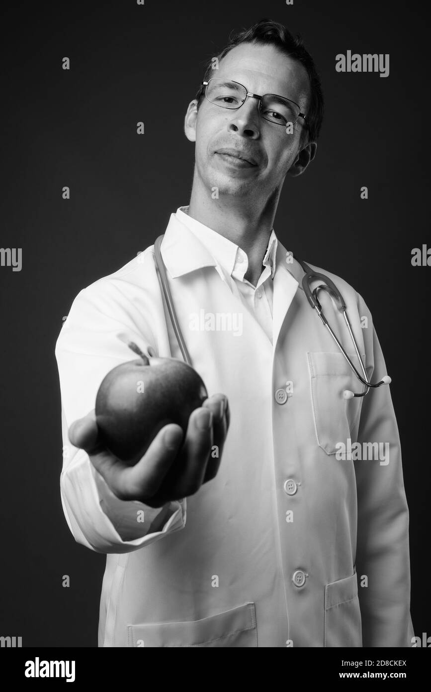 Doctor giving shot to man Black and White Stock Photos & Images - Alamy