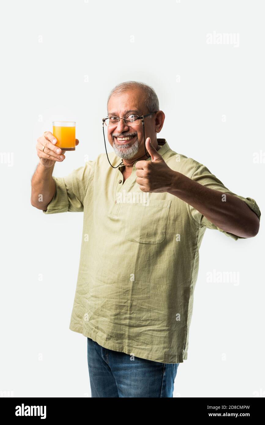 Indian asian senior or old man drinking 