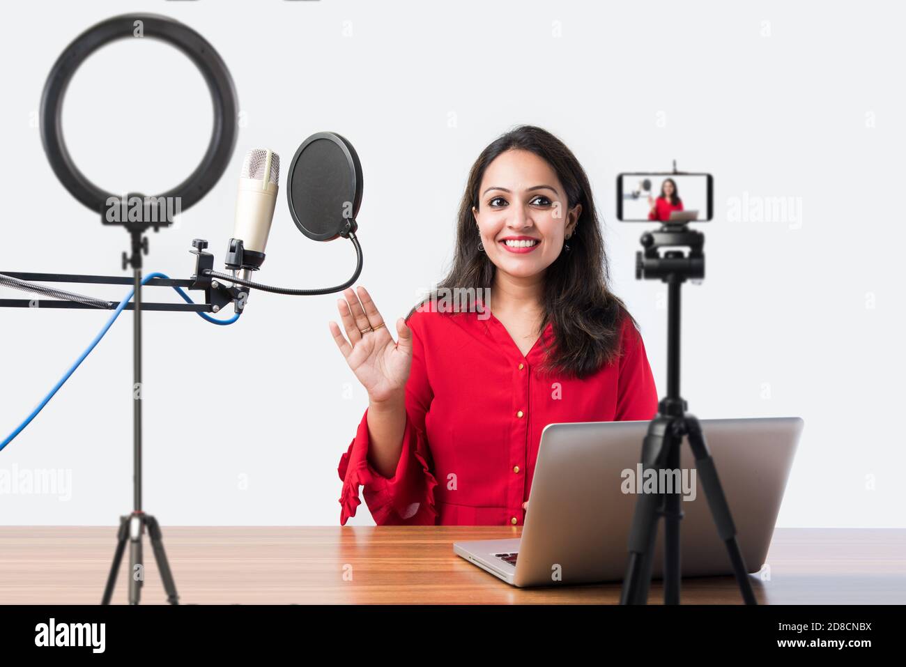 Pretty Indian woman speaks in front of microphone while recording a