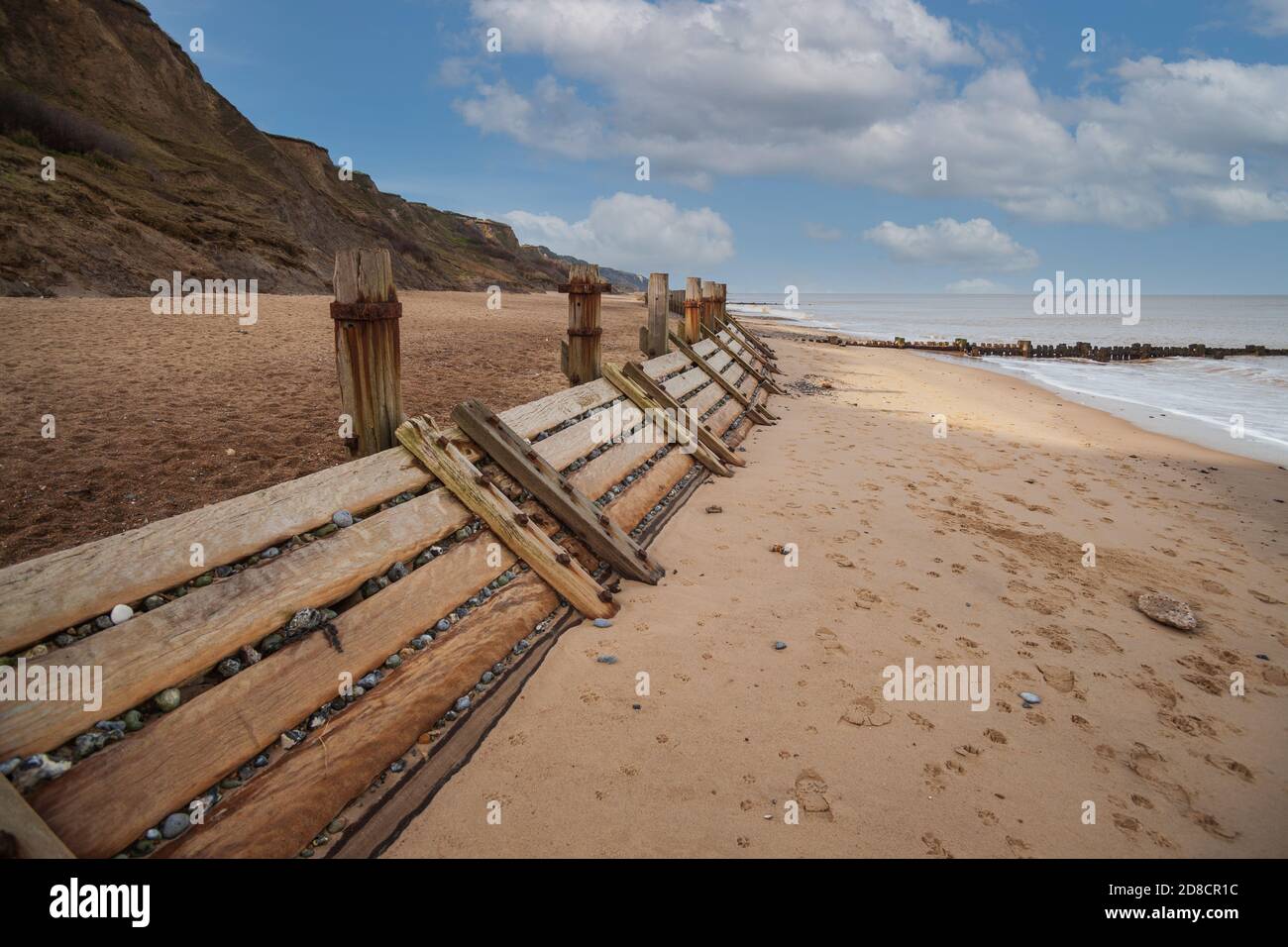 wooden beach groynes, coastal sea defences at overstrand on the norfolk coast england Stock Photo