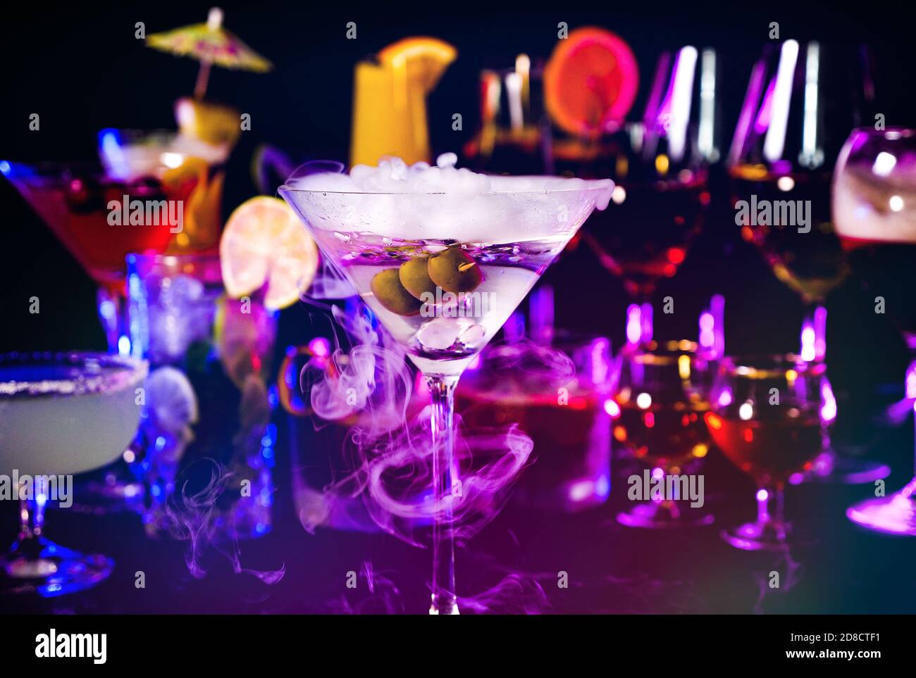 Close up of dry Martini drink with olives at bar counter on a ...