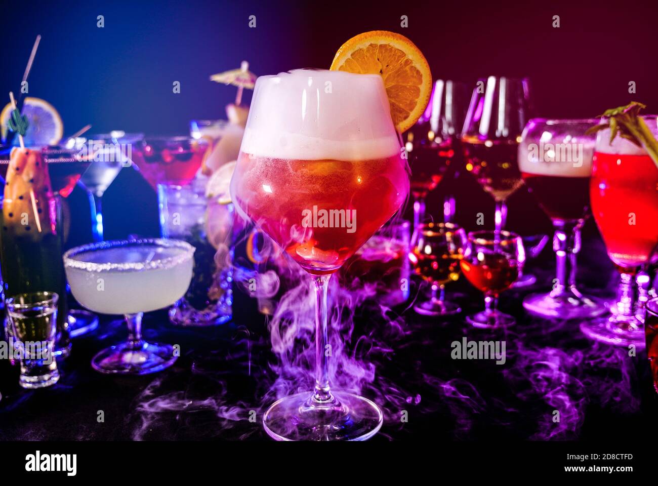 Aperol spritz drink with dry ice at bar counter close up. Bartender show and prepared cocktail with dry ice on a cocktail bar background. Stock Photo