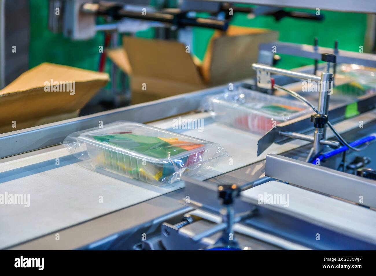 Box with food on conveyor belt in distribution warehouse. parcels