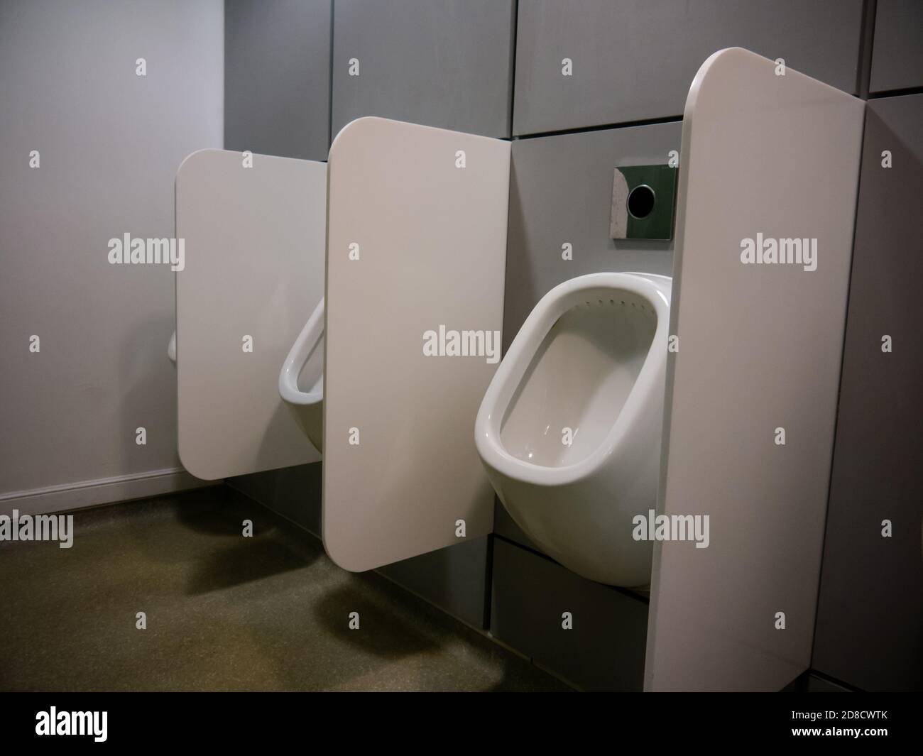 Urinals in a men's toilets with privacy screens Stock Photo Alamy