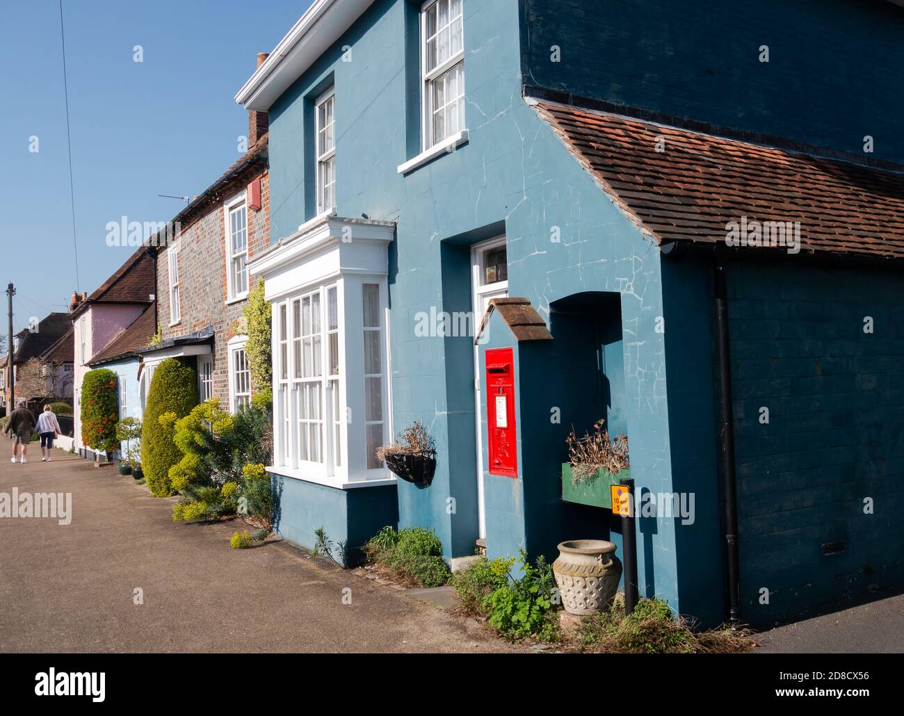A cottage with a post box built into its external walls, in the village of Portchester, Hampshire, England Stock Photo