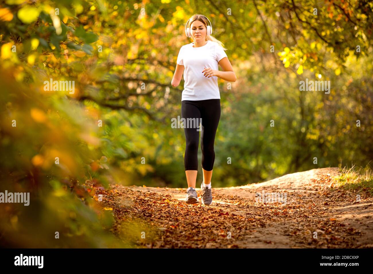 Young attractive woman in a yoga pose, laughing and enjoying