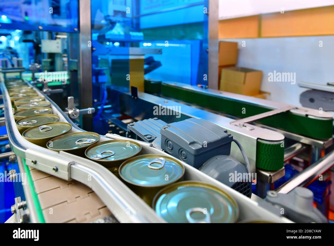 Canned food products on conveyor belt in distribution warehouse