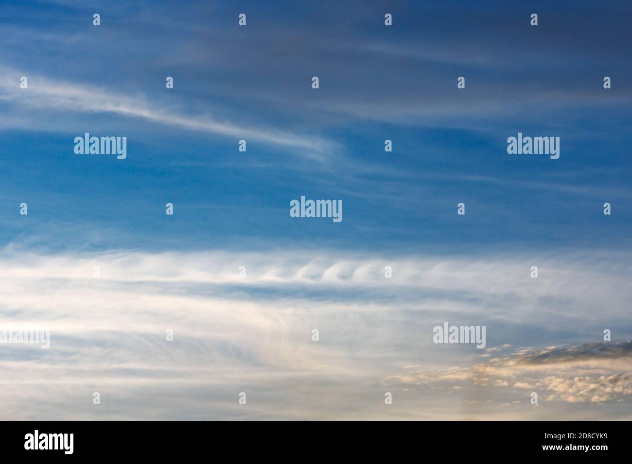 Kelvin, Helmholtz instability clouds wavy on blue sky, feathery curls Stock Photo