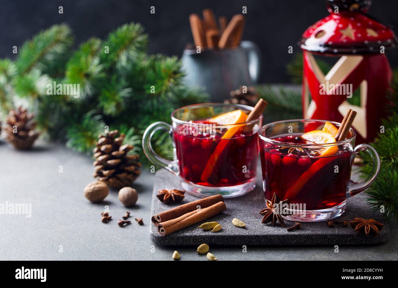 Mulled red wine with spices. Christmas decoration. Grey stone background. Copy space. Stock Photo