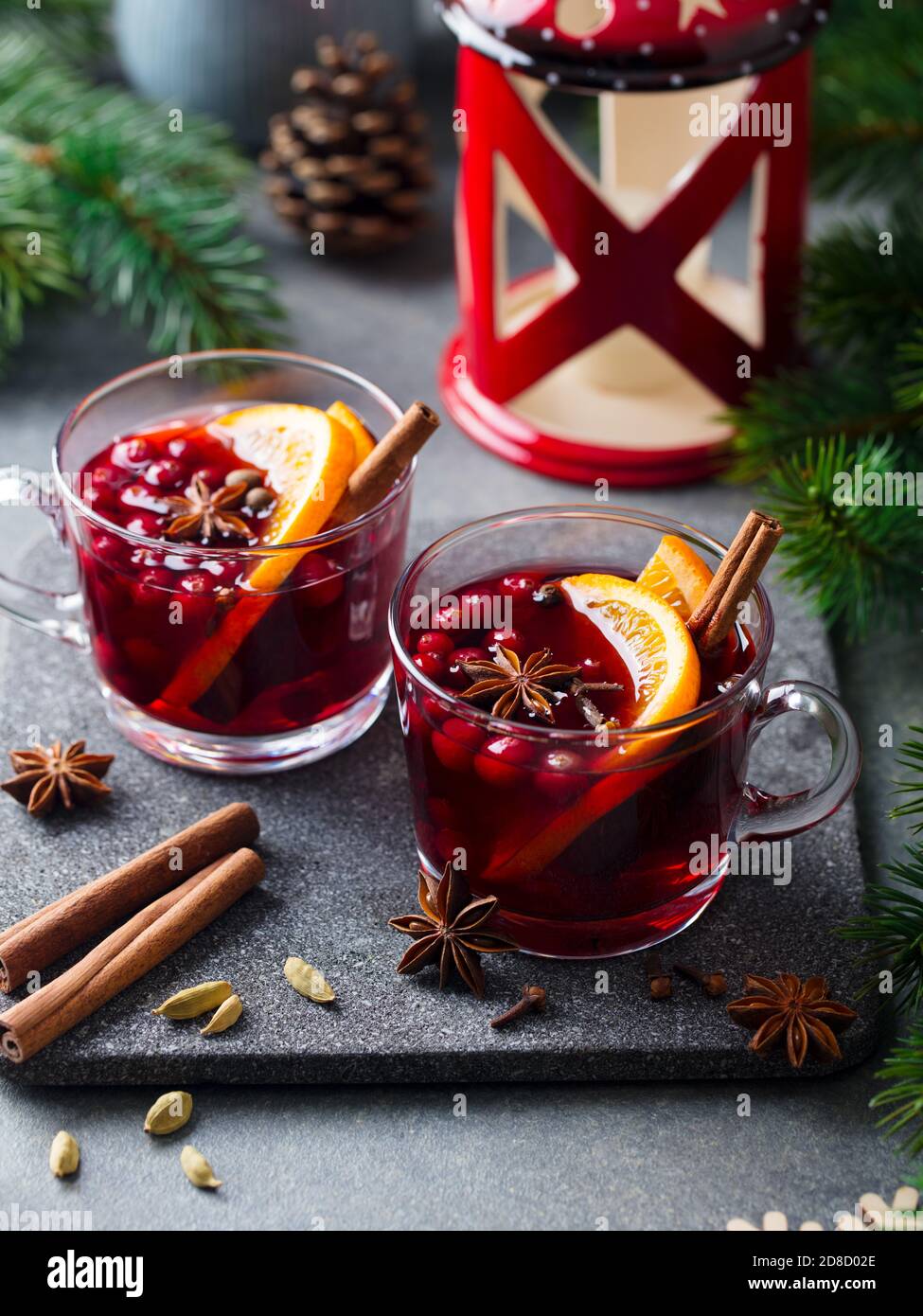 Mulled red wine with spices. Christmas decoration. Grey stone background. Close up. Stock Photo