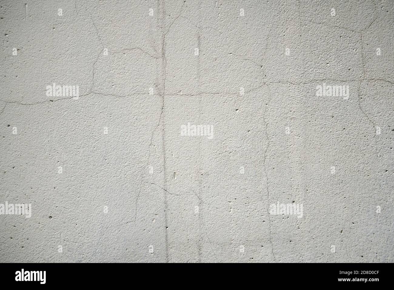 Old cracked grey concrete wall, weathered building background. Stock Photo