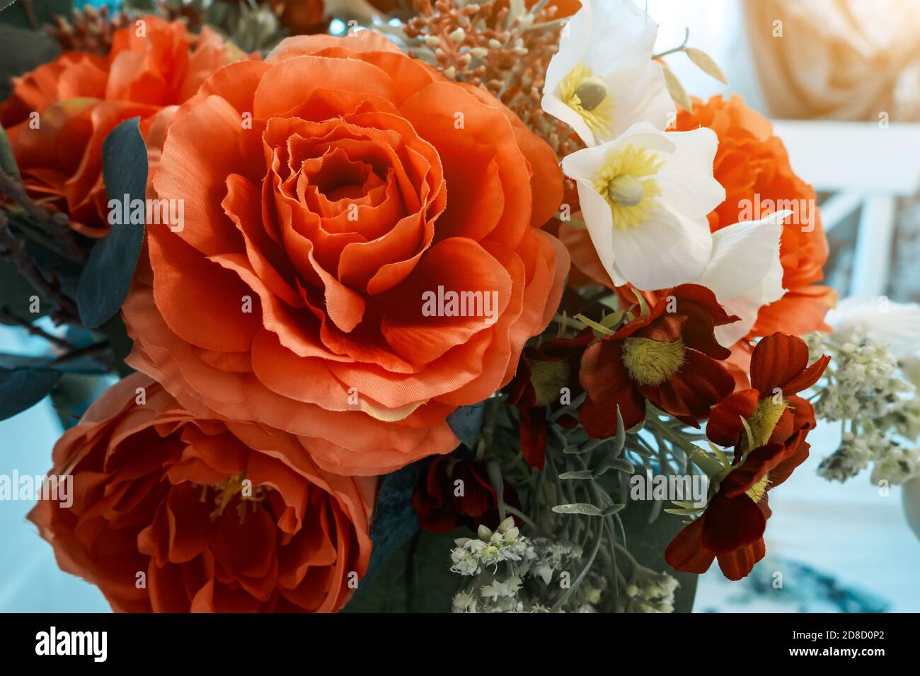 colorful bouquet of artificial flowers made of fabric, fake red roses Stock Photo