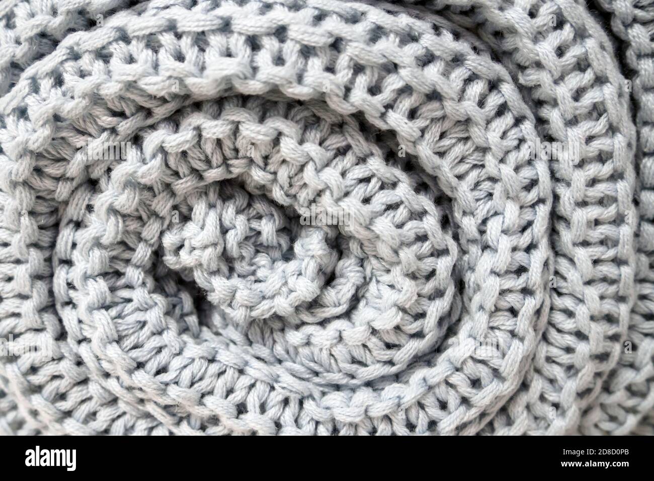 close-up of roll gray knitted plaid, soft selective focus Stock Photo
