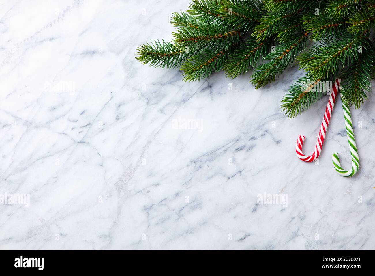 Christmas and New Year decoration, fir tree and candy canes. Marble background. Copy space. Top view? Stock Photo