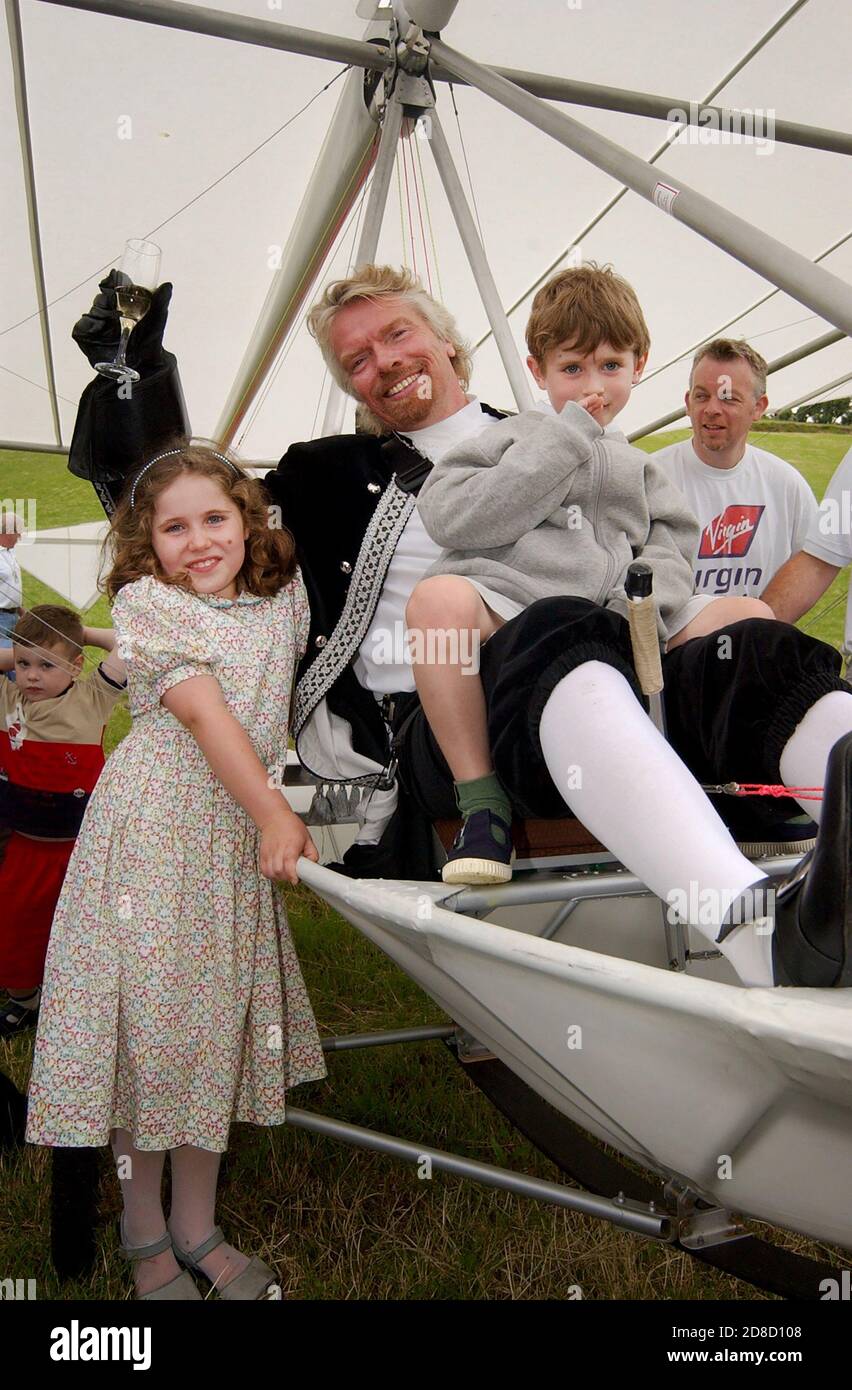 Richard Branson celebrates after he recreated the flight of Sir George  Cayley's glider in a replica aircraft, at Brompton, Near Scarborough, North Yo Stock Photo