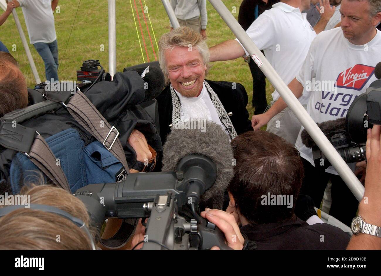 Richard Branson celebrates after he recreated the flight of Sir George  Cayley's glider in a replica aircraft, at Brompton, Near Scarborough, North Yo Stock Photo