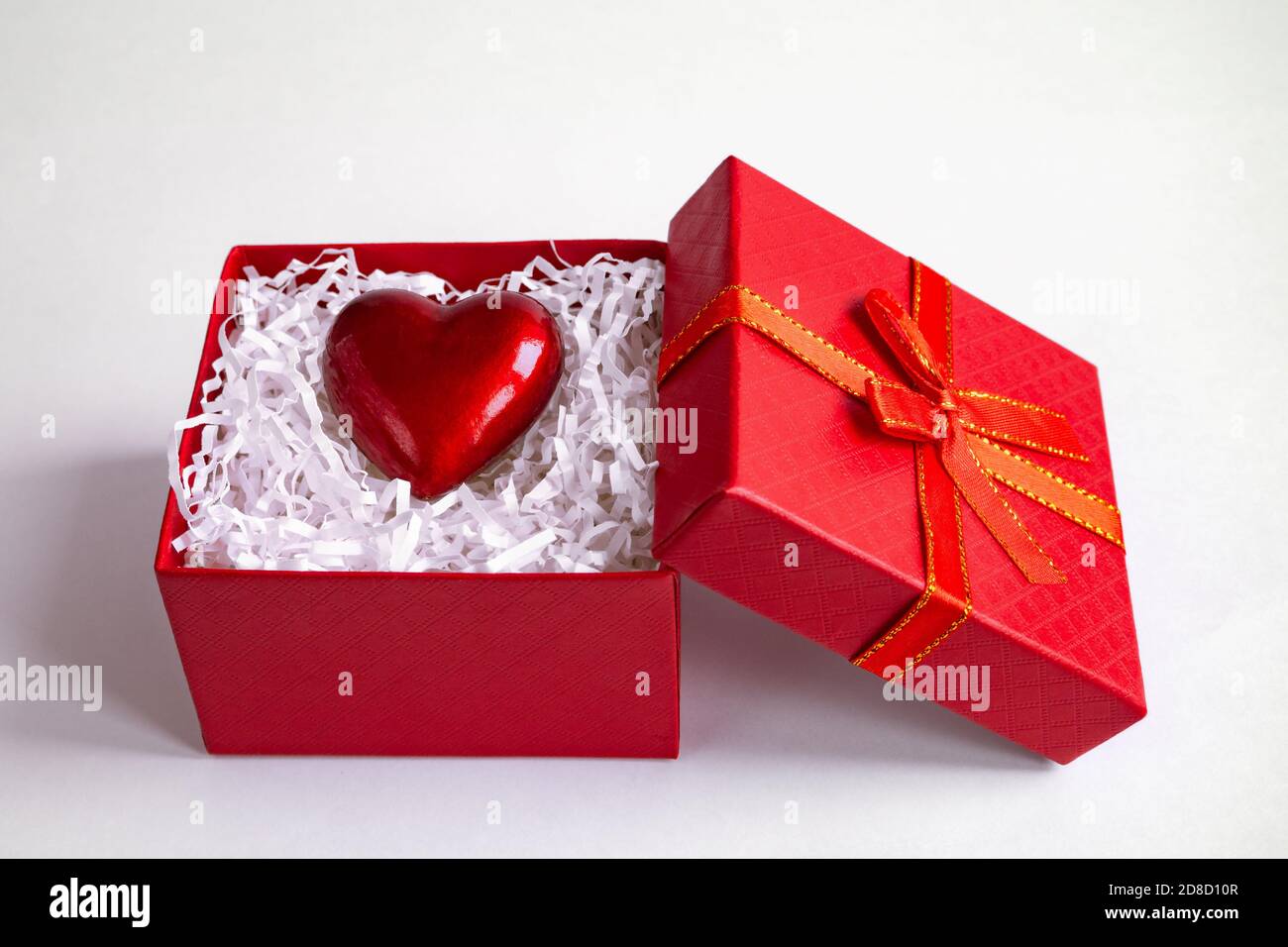 red gift box with heart by on white background, St. Valentine's day concept Stock Photo