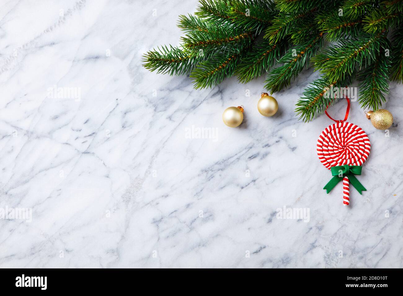 Christmas and New Year decoration, fir tree and ornaments. Marble background. Copy space. Top view. Stock Photo